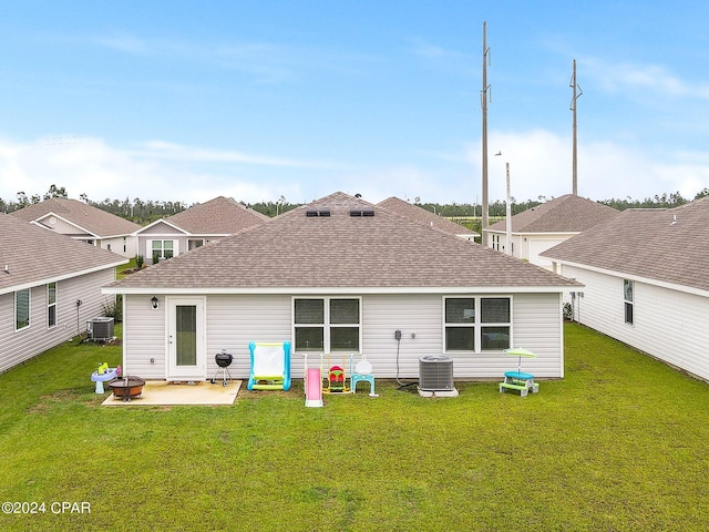 rear view of house featuring a lawn, cooling unit, and a patio