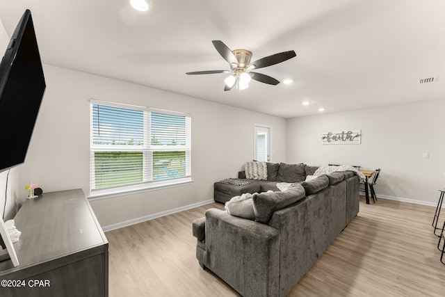 living room with ceiling fan and light hardwood / wood-style floors