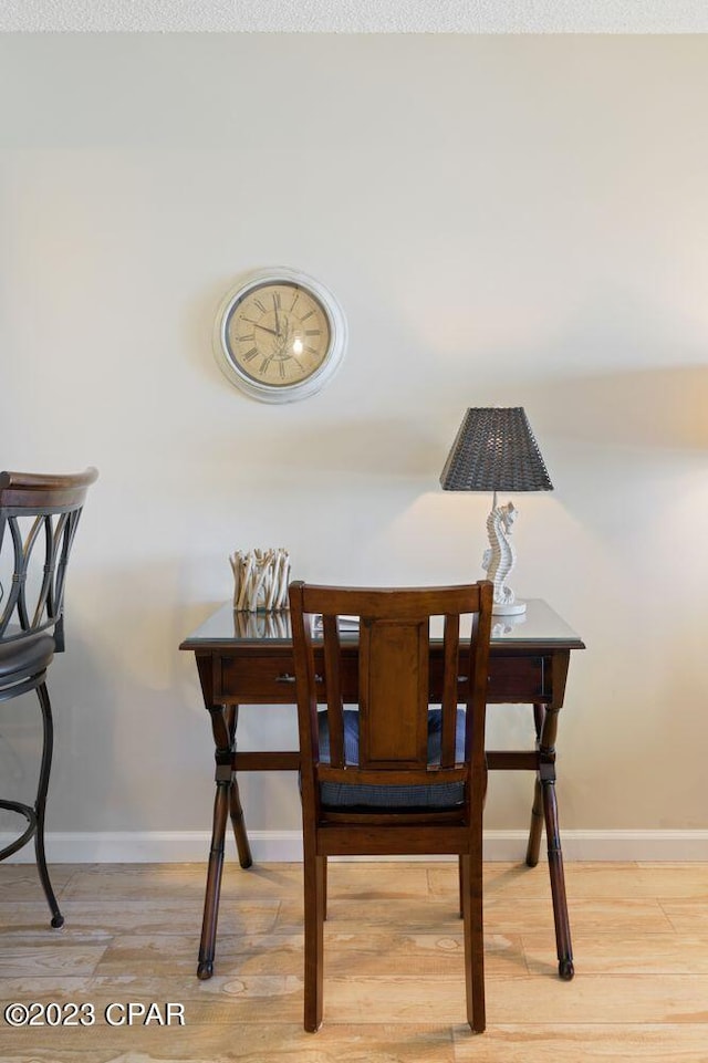 dining area with wood finished floors and baseboards