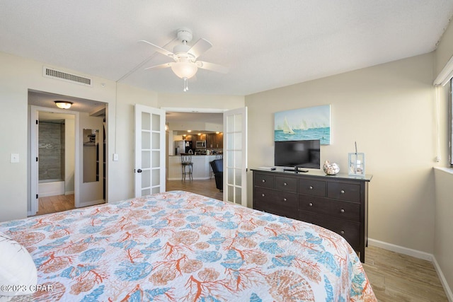 bedroom with stainless steel fridge, baseboards, visible vents, wood finished floors, and french doors