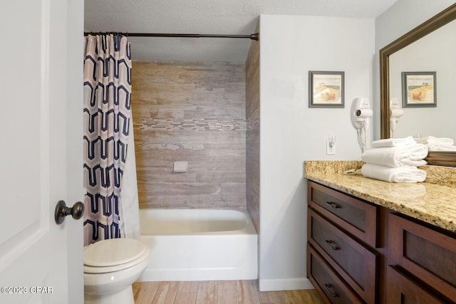 full bathroom featuring vanity, a textured ceiling, toilet, and wood finished floors