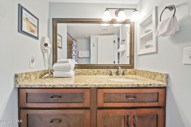 full bathroom featuring a shower with curtain and vanity