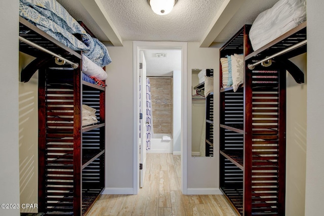 spacious closet with visible vents and wood finished floors