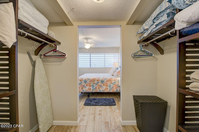 spacious closet with a ceiling fan and wood finished floors