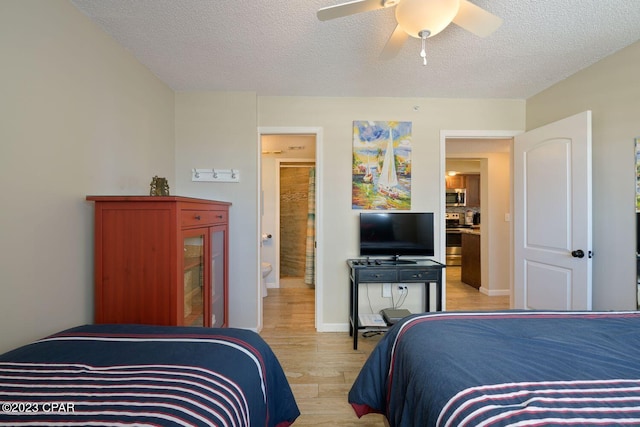 bedroom featuring a ceiling fan, baseboards, light wood-style flooring, and a textured ceiling