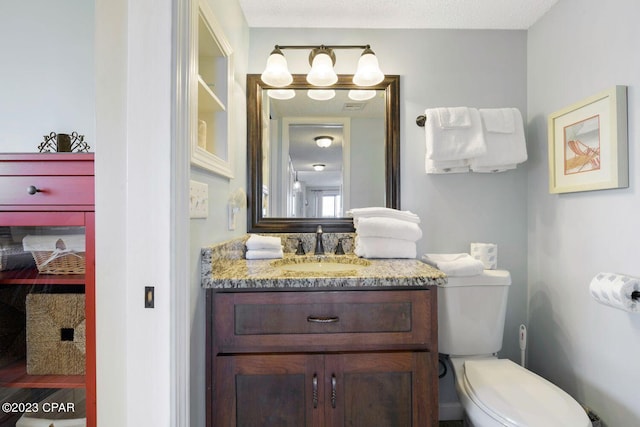 bathroom featuring toilet and vanity