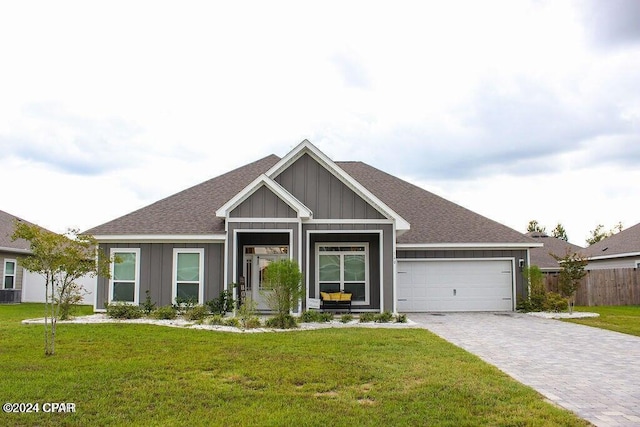 view of front of home with a front yard and a garage