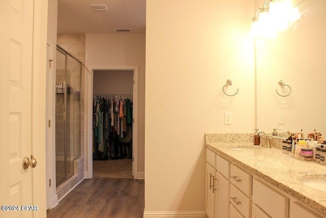 bathroom with vanity, wood-type flooring, and an enclosed shower