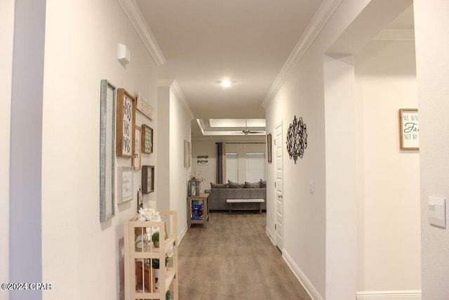 corridor with hardwood / wood-style floors and ornamental molding