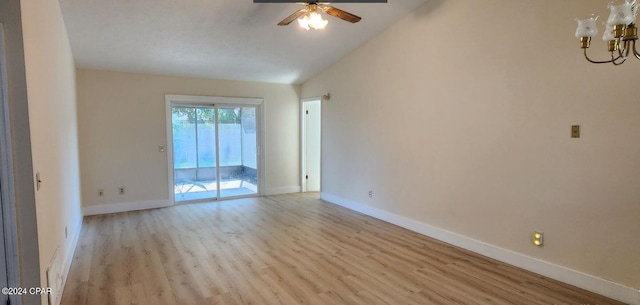 spare room featuring ceiling fan with notable chandelier and light hardwood / wood-style floors