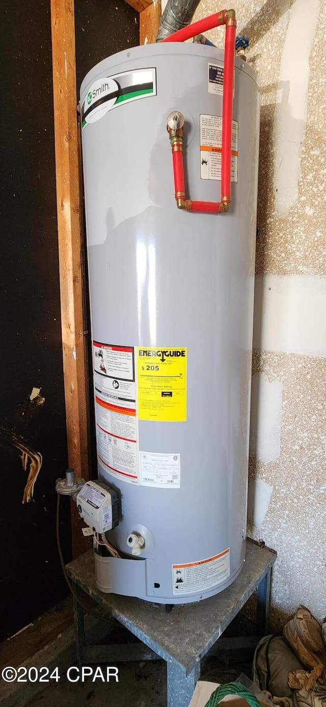 utility room featuring water heater