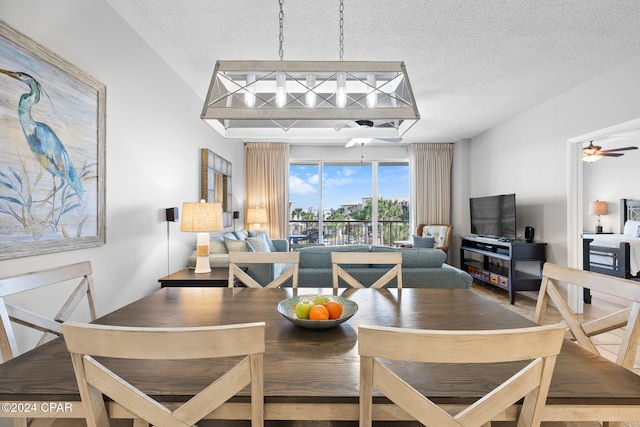 dining room with a textured ceiling and ceiling fan