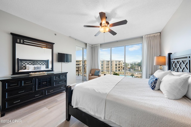 10254 E County Highway 30a Unit 333, Rosemary Beach, FL 32461 - bedroom featuring access to exterior, light wood finished floors, a textured ceiling, and ceiling fan