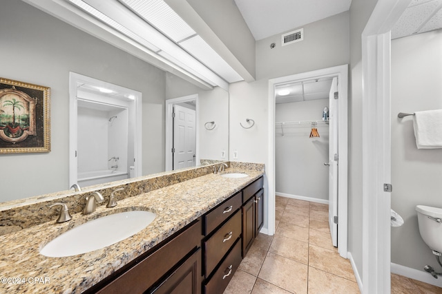 bathroom featuring vanity, a tub, and tile patterned floors