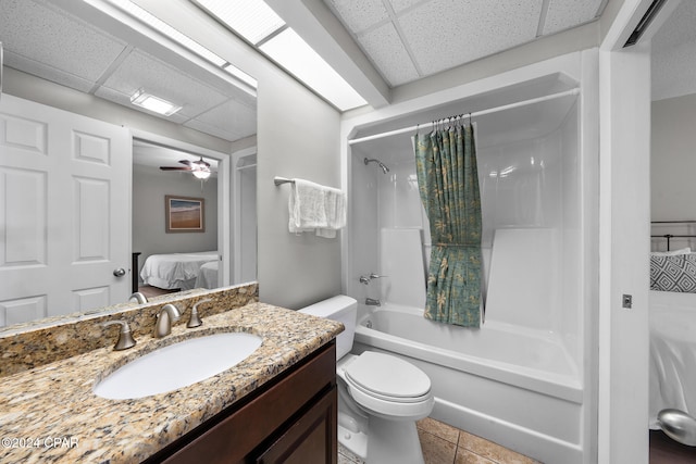 full bathroom featuring vanity, toilet, tile patterned flooring, shower / tub combo with curtain, and ceiling fan