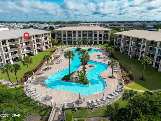 view of swimming pool with a patio area and a yard