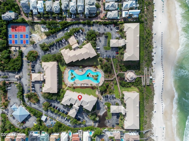 drone / aerial view featuring a beach view and a water view