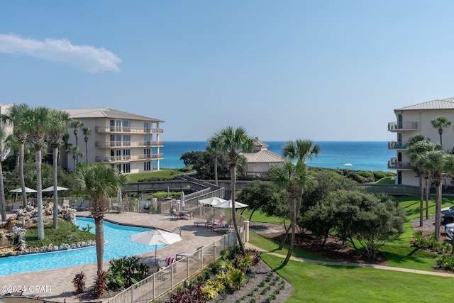 view of swimming pool with a water view, a yard, and a gazebo