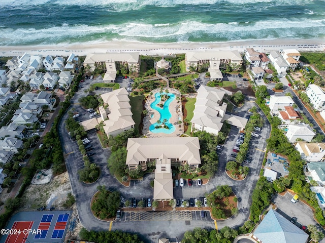 birds eye view of property with a water view and a view of the beach