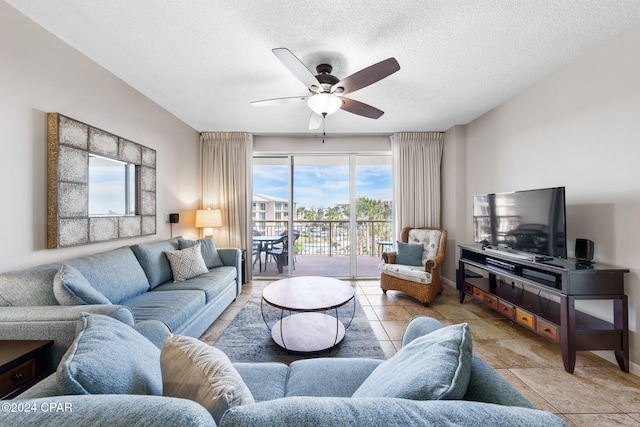 living room with a textured ceiling and ceiling fan