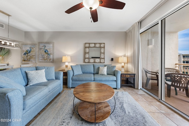 living room with ceiling fan and light tile patterned flooring