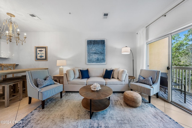 living room with an inviting chandelier, light tile patterned floors, and a healthy amount of sunlight