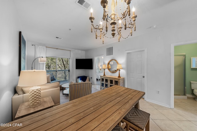 dining space with light tile patterned flooring and an inviting chandelier