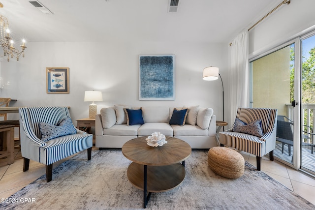 tiled living room featuring a notable chandelier and a healthy amount of sunlight