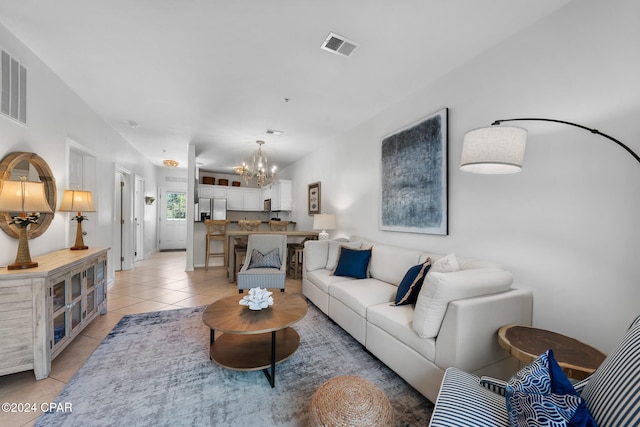 living room with light tile patterned flooring and a chandelier