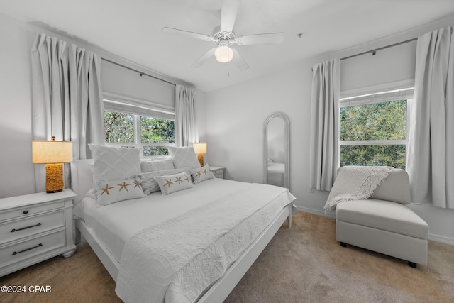 bedroom featuring light carpet and ceiling fan