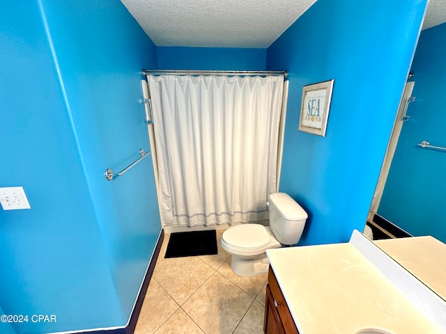 bathroom with tile patterned floors, toilet, a shower with shower curtain, vanity, and a textured ceiling