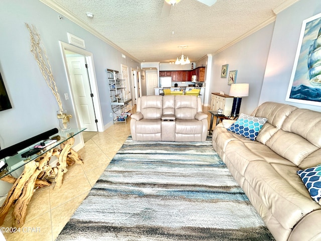 living room with ornamental molding, a textured ceiling, ceiling fan with notable chandelier, and light tile patterned floors