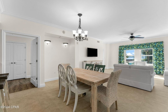 dining room featuring ceiling fan with notable chandelier, light tile patterned floors, baseboards, and ornamental molding