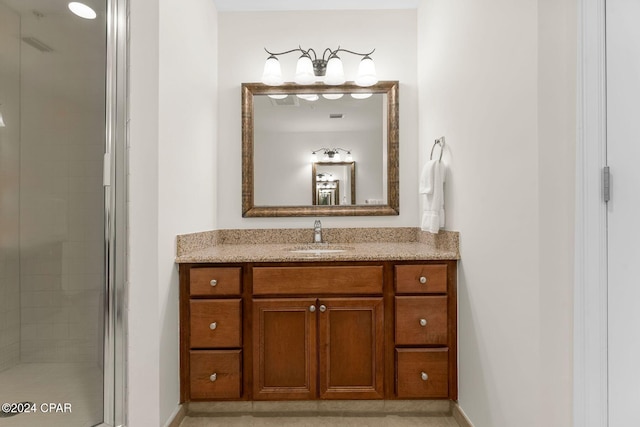 bathroom with vanity and a shower with door