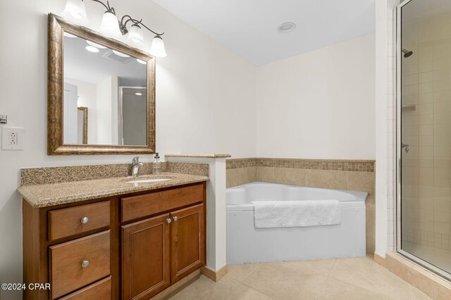 bathroom featuring vanity, shower with separate bathtub, and tile patterned flooring