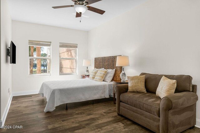 bedroom with ceiling fan and dark hardwood / wood-style floors