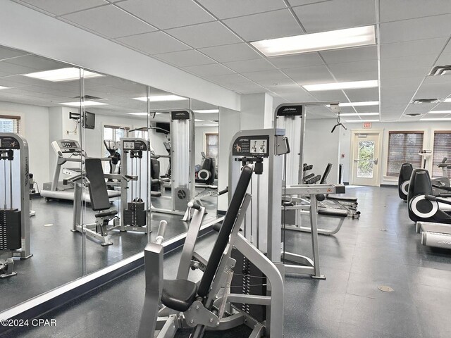 gym with a paneled ceiling