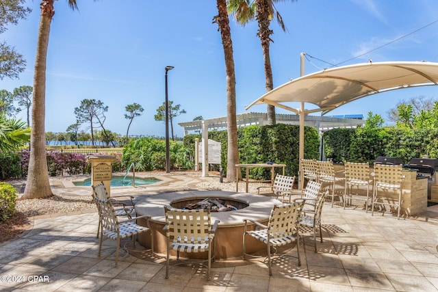 view of patio / terrace with an outdoor fire pit and area for grilling