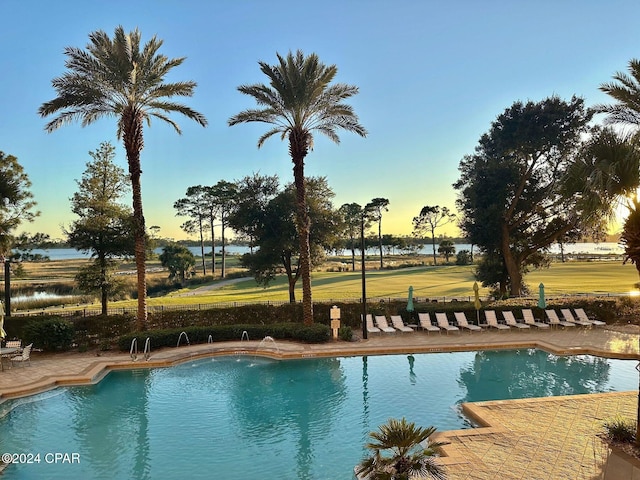 pool at dusk with a patio