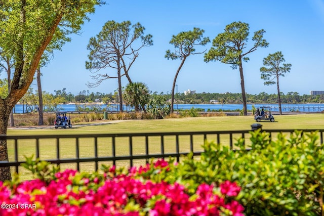 view of home's community featuring a water view and a yard