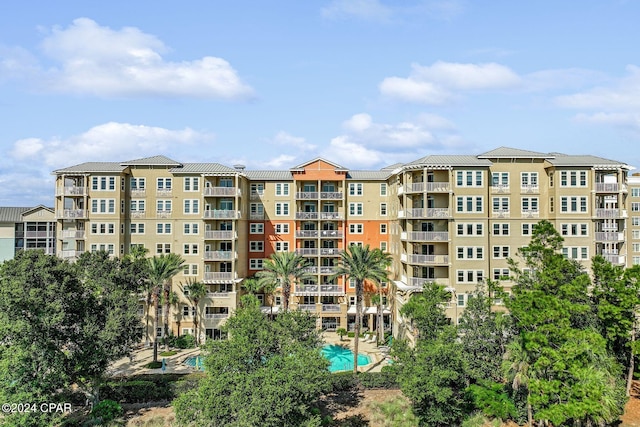 view of building exterior with a community pool