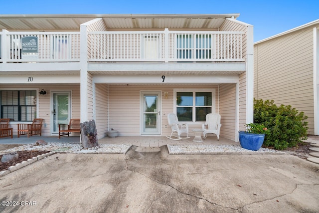 back of house featuring a patio area and a balcony