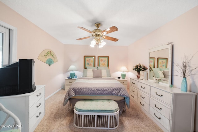 bedroom featuring ceiling fan and light carpet