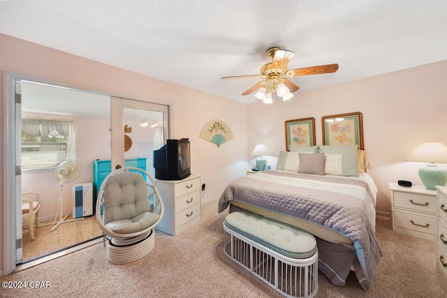 bedroom featuring ceiling fan and light carpet