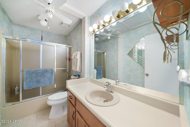 full bathroom featuring vanity, toilet, enclosed tub / shower combo, and tile patterned flooring