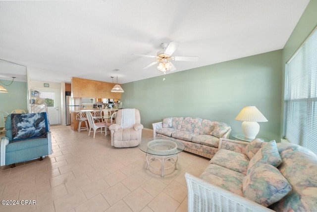 tiled living room featuring ceiling fan