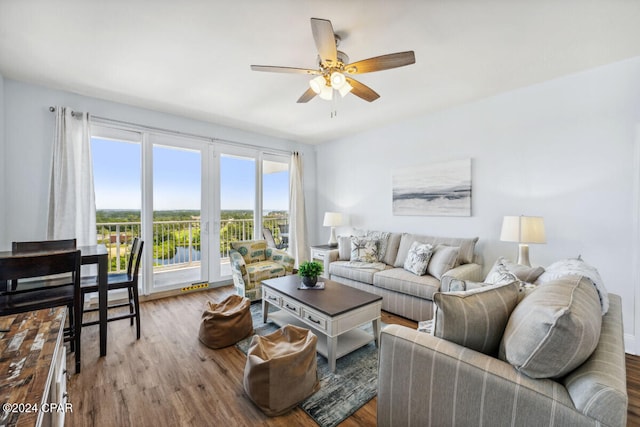 living room featuring ceiling fan and wood-type flooring