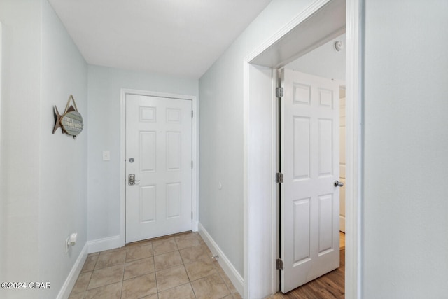 corridor with light tile patterned floors