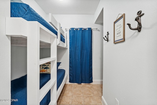 bedroom featuring light tile patterned flooring