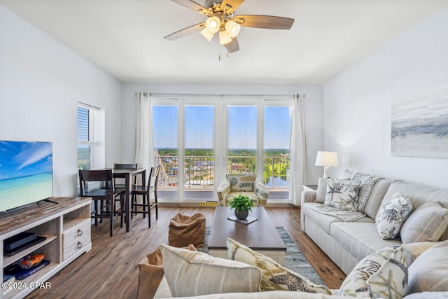 living room featuring dark hardwood / wood-style flooring and ceiling fan